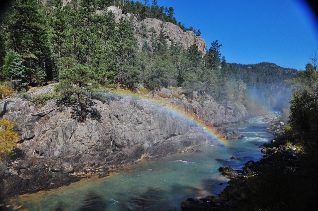 rainbow over the river created by the engine steam
